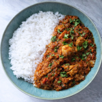 brussels sprout curry served with rice in a bowl with fresh coriander