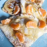 chocolate orange crepes with icing sugar and syrup